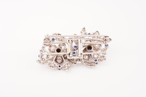 Lot 43 - A floral duette brooch set with sapphires and...