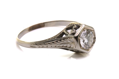 Lot 128 - A diamond solitaire ring, scintillating with...