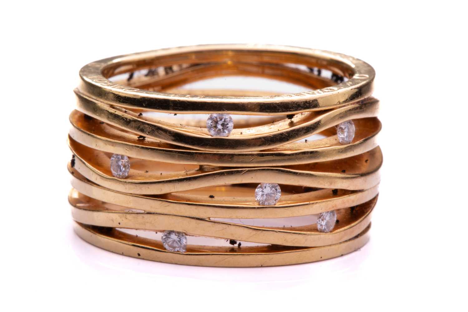 Lot 219 - Omega - A seven-row ring set with diamonds in...