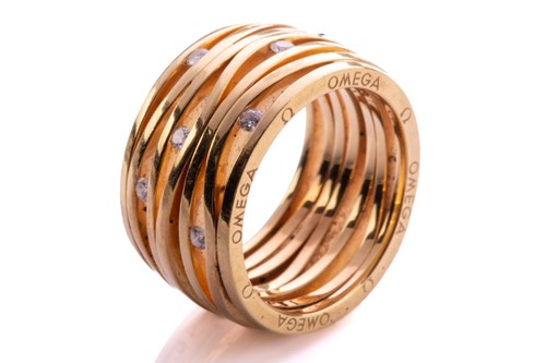 Lot 219 - Omega - A seven-row ring set with diamonds in...