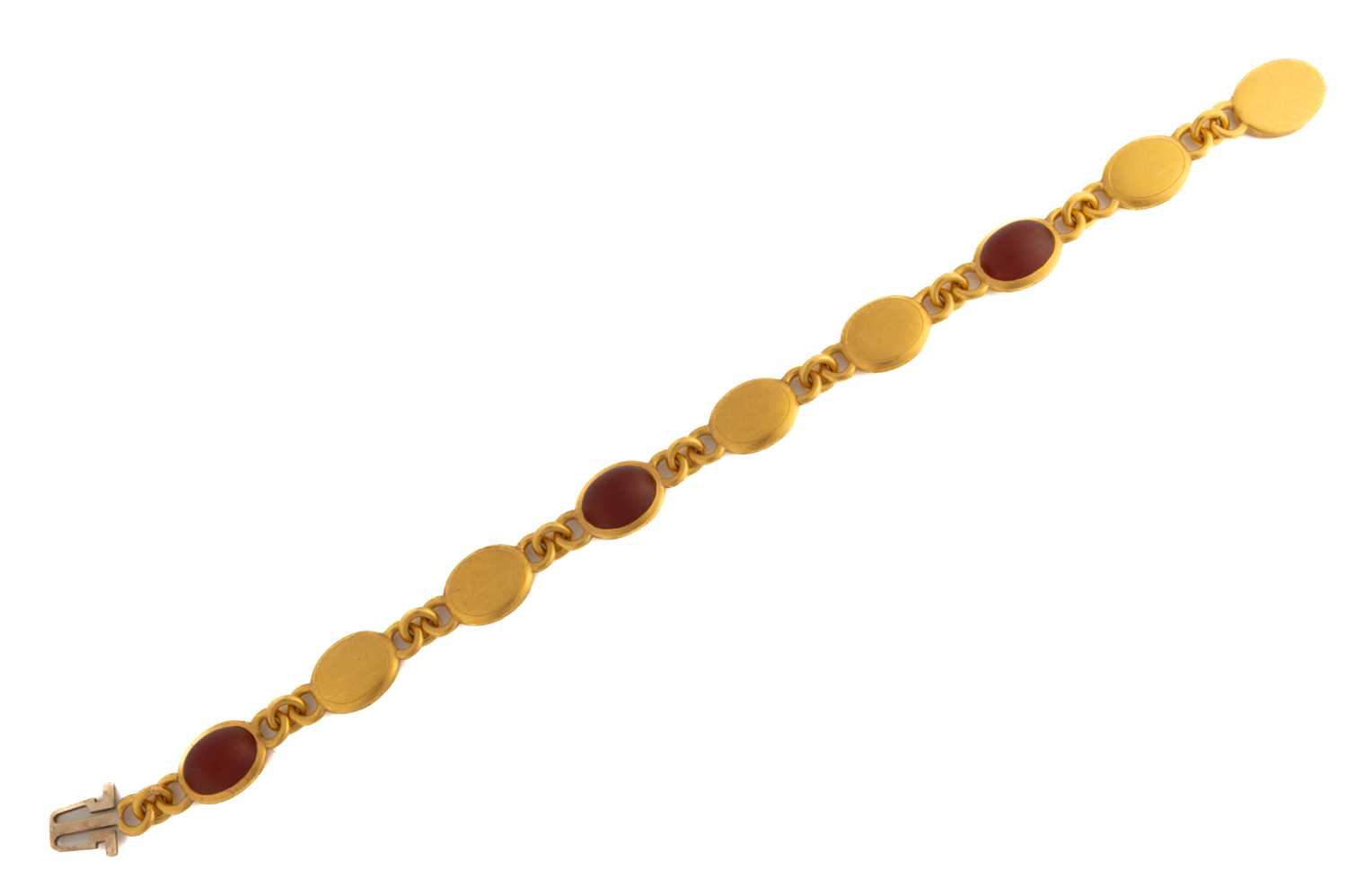 Lot 94 - A 22ct yellow gold and carnelian bracelet,...