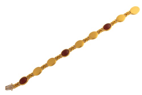 Lot 94 - A 22ct yellow gold and carnelian bracelet,...