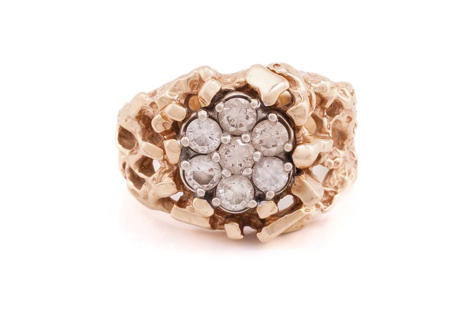 Lot 365 - A seven stone diamond cluster ring; the round...