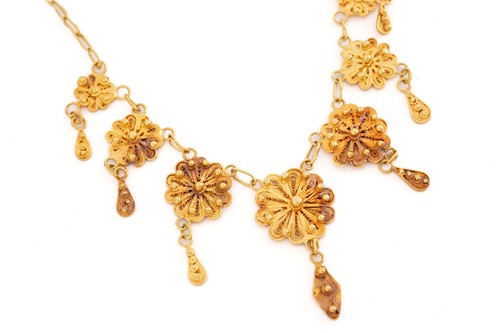 Lot 325 - A yellow gold filigree necklace, set with...