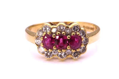 Lot 192 - A ruby and diamond cluster ring in 18ct gold,...