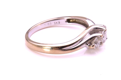 Lot 36 - A three-stone diamond crossover ring in 18ct...