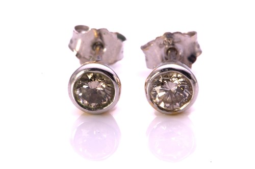 Lot 106 - A pair of diamond earrings in 18ct white gold,...