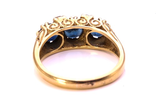 Lot 100 - A sapphire and diamond half hoop ring in 18ct...