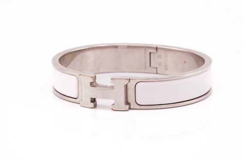 Lot 66 - Hermès - A narrow 'Clic H' bracelet with pale...