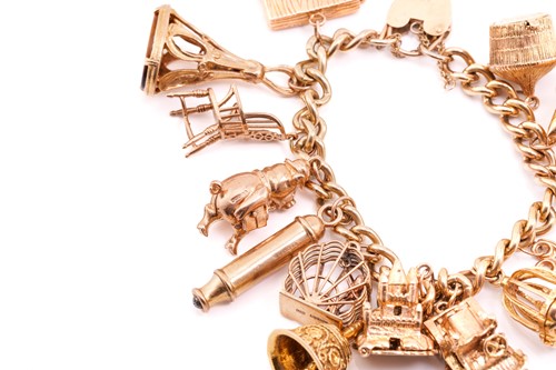 Lot 79 - A 9 carat gold charm bracelet; the curb...