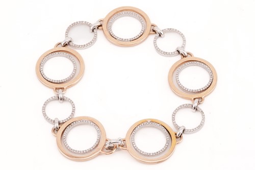 Lot 9 - A diamond hoop bracelet, the rose gold and...