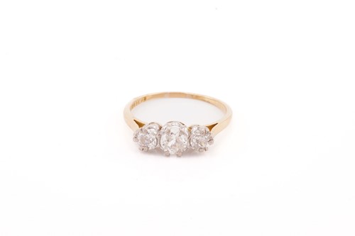 Lot 59 - A three-stone diamond half-hoop ring,...