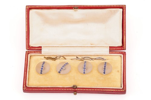 Lot 18 - A cased set of four rock crystal and sapphire...