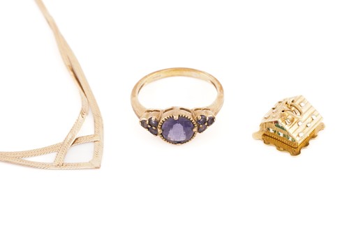 Lot 235 - A 9ct yellow gold and purple gemstone ring,...