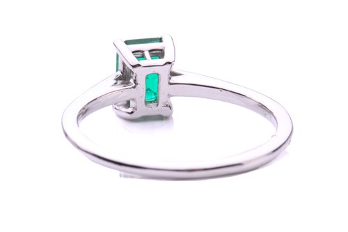 Lot 50 - An emerald solitaire ring, featuring an...