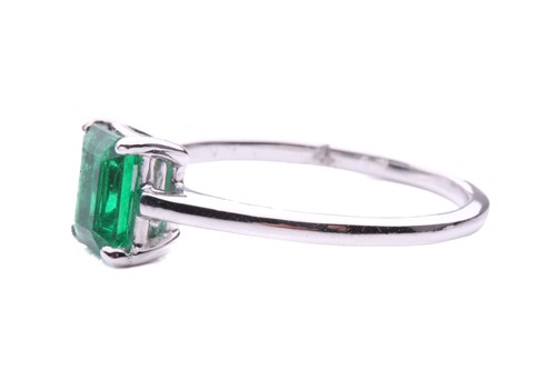 Lot 50 - An emerald solitaire ring, featuring an...