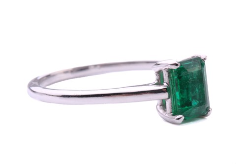Lot 50 - An emerald solitaire ring, featuring an...