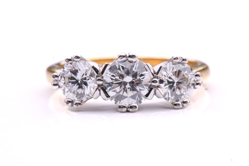 Lot 181 - A three-stone diamond half-hoop ring in 18ct...
