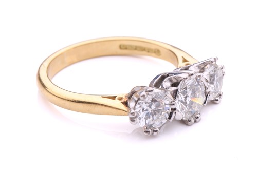 Lot 181 - A three-stone diamond half-hoop ring in 18ct...