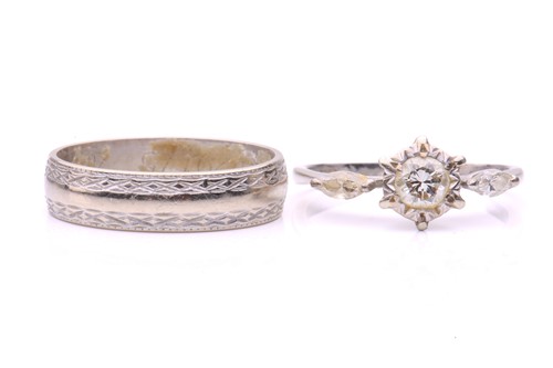 Lot 218 - A three-stone diamond ring and a wedding band...