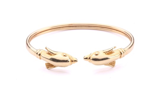 Lot 230 - A dolphin torque bangle, with a plain band...