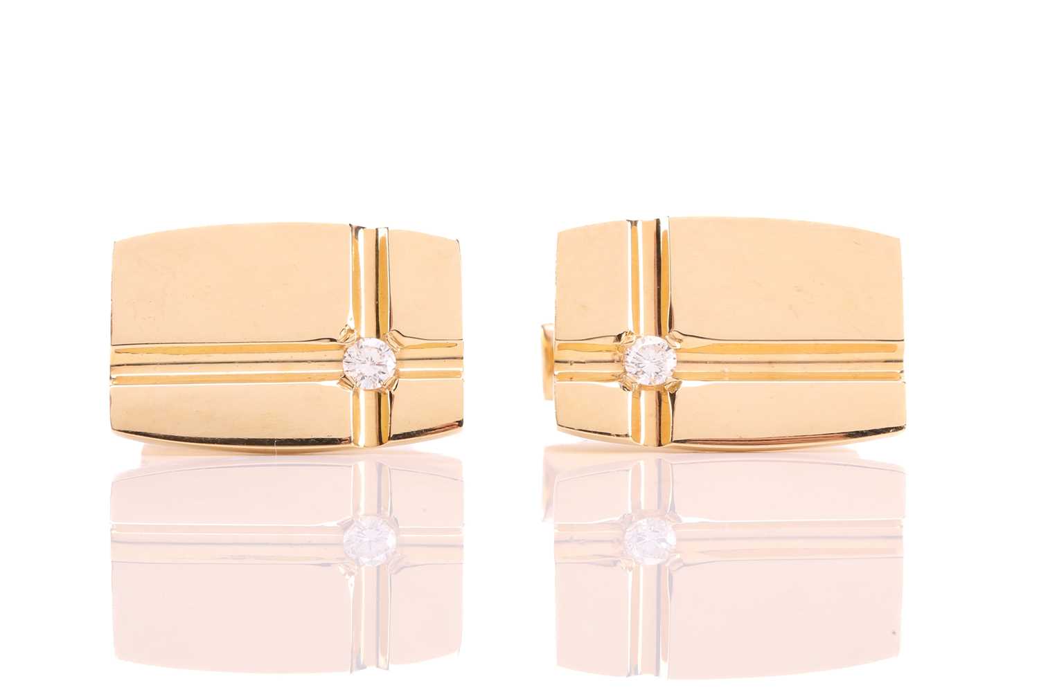 Lot 64 - A pair of cufflinks with diamond accents, each...