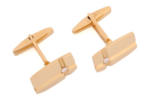 Lot 64 - A pair of cufflinks with diamond accents, each...