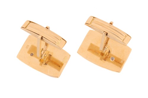 Lot 64 - A pair of cufflinks with diamond accents, each...