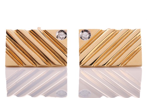 Lot 118 - A pair of cufflinks with diamond accents, each...