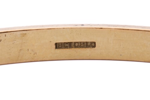 Lot 217 - A yellow metal closed bangle, with a solid...