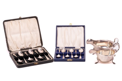 Lot 374 - A silver sauce boat, and two cased sets of...