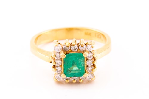 Lot 43 - An emerald and diamond entourage ring, centred...