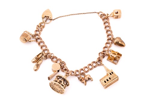 Lot 113 - A 9ct gold charm bracelet with nine assorted...