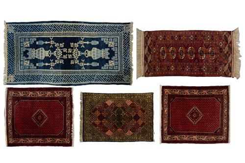 Lot 560 - An old dark blue ground "Peking" rug with a...