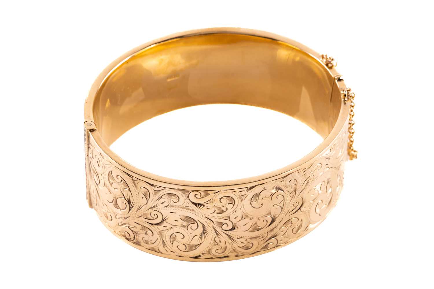 Lot 17 A 9ct yellow gold hinged bangle, the hollow