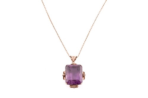 Lot 39 - A large amethyst pendant on chain, contains an...