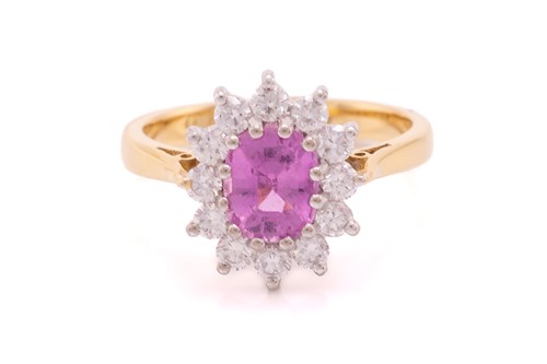 Lot 68 - A pink sapphire and diamond cluster ring in...