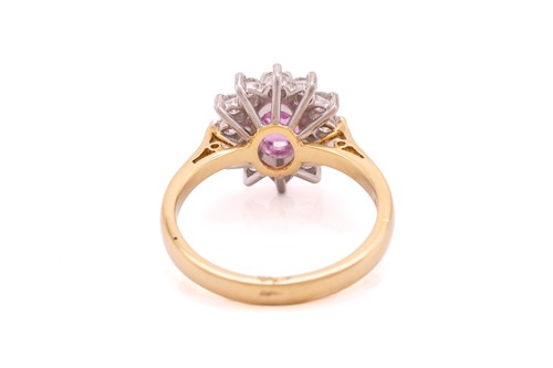Lot 68 - A pink sapphire and diamond cluster ring in...