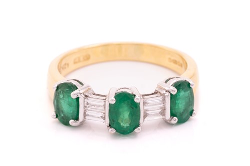 Lot 8 - An emerald and diamond dress ring in 18ct...