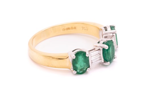 Lot 8 - An emerald and diamond dress ring in 18ct...