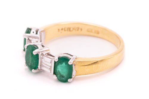 Lot 8 - An emerald and diamond dress ring in 18ct...