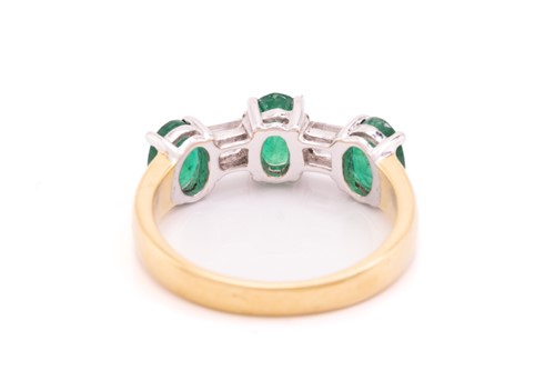 Lot 8 - An emerald and diamond dress ring in 18ct...