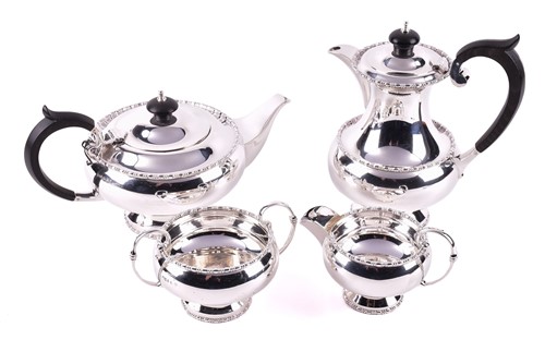 Lot 375 - A four piece silver tea service, of circular...