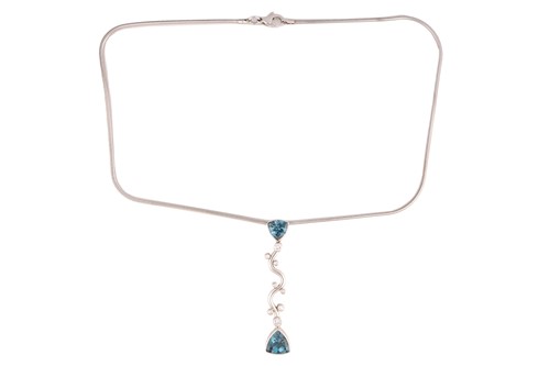 Lot 339 - A topaz and diamond pendant on chain, the...