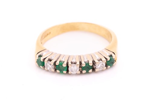 Lot 210 - A seven-stone emerald and diamond half-hoop...