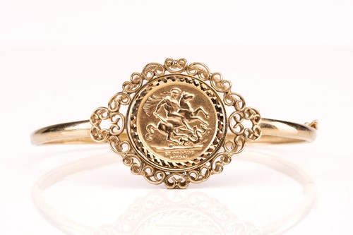 Lot 188 - A 9ct gold hinged bangle, set with embossed...