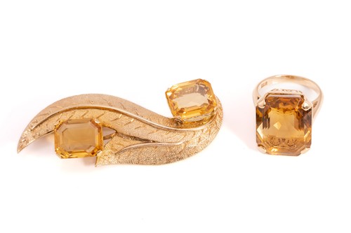 Lot 48 - A citrine brooch, matching earrings and a ring...