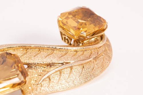 Lot 48 - A citrine brooch, matching earrings and a ring...