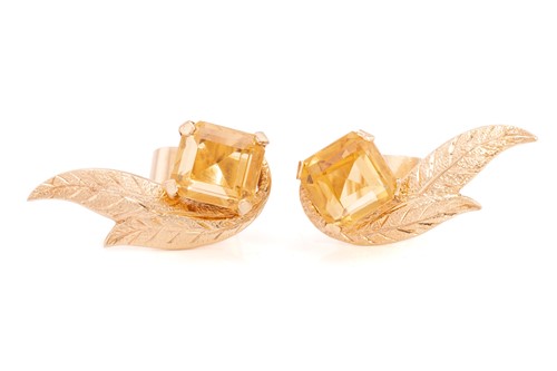 Lot 48 - A citrine brooch, matching earrings and a ring...