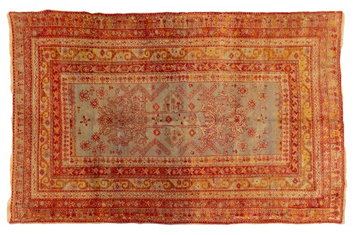 Lot 118 - An old Turkish rug with a subtle green ground...